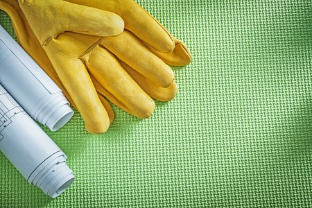 Protective leather gloves engineering drawings on green background construction concept.の写真素材