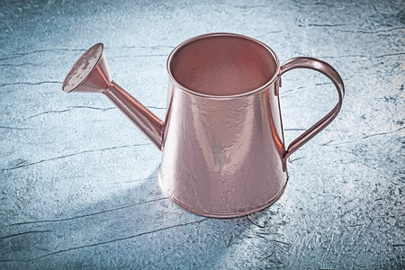 Vintage watering can on metallic background gardening concept.の写真素材