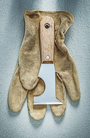 Plastering trowel leather protective gloves on concrete background construction concept.の写真素材
