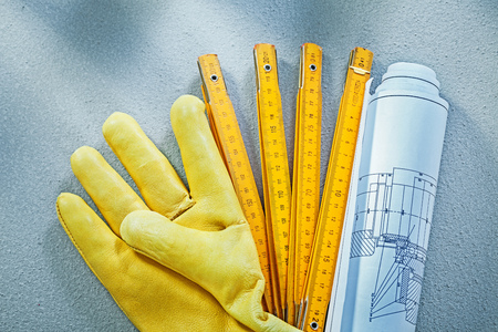 Set of working gloves construction drawings wooden meter on concrete background building concept.の写真素材
