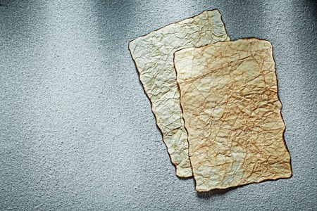 Vintage blank crumpled sheets of paper on grey background.の写真素材