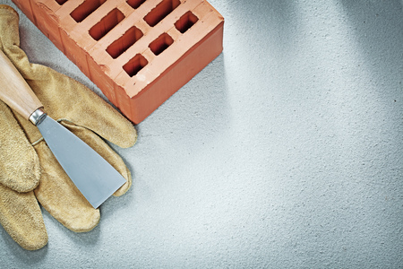 Building bricks leather safety gloves paint scraper on concrete background bricklaying concept.の写真素材