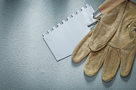 Paint scraper leather protective gloves on concrete background construction concept.の写真素材