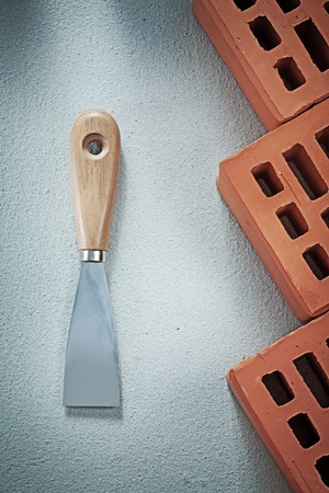 Red brick plastering trowel on concrete background building concept.の写真素材