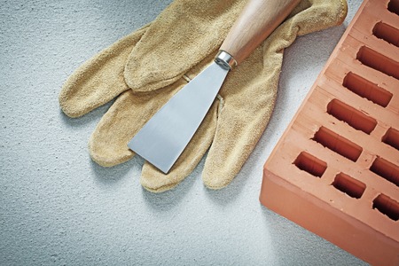 Orange bricks protective gloves construction spatula on concrete background bricklaying concept.の写真素材