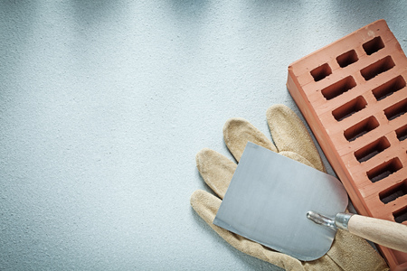 Construction brick leather protective gloves plastering trowel on concrete surface bricklaying concept.の写真素材