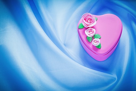 Pink gift box on blue fabric background celebrations concept.の写真素材