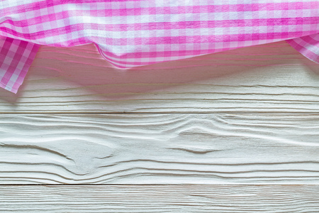 Pink checked fabric on wooden board.の写真素材