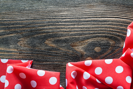 Red polka-dot table cloth on wood board top view.の写真素材
