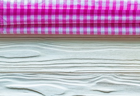 Pink squared cotton tablecloth on wooden board.の写真素材