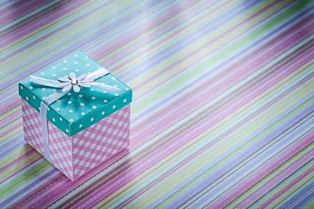 Gift box with ribbon on striped fabric surface holidays concept.の写真素材