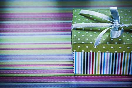 Decorated gift box on striped fabric holidays concept.の写真素材
