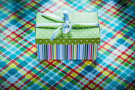 Gift box on colorful checked tablecloth holidays concept.の写真素材