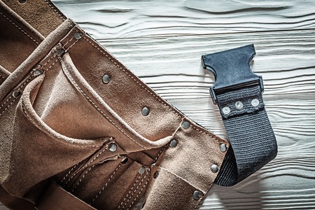 Leather tool belt on white board.の写真素材
