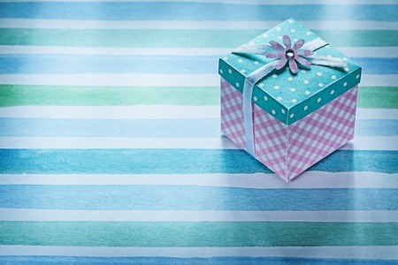 Packed gift box on blue striped fabric holidays concept.の写真素材