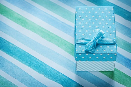 Packed gift box on blue striped table cloth holidays concept.の写真素材