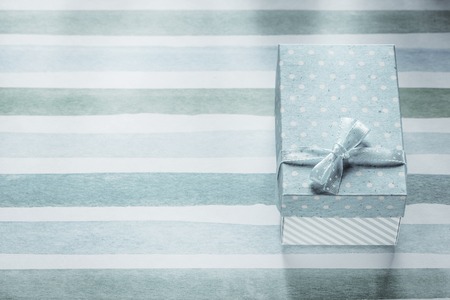 Packed present box on blue striped table cloth holidays concept.の写真素材