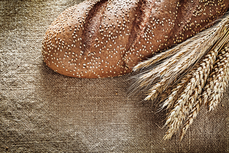 Rye ears bread on burlap background.の写真素材