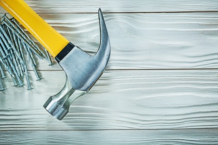 Claw hammer construction nails on wood board.の写真素材