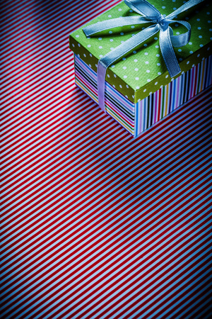 Gift in cardboard box on red striped tablecloth celebrations concept.の写真素材