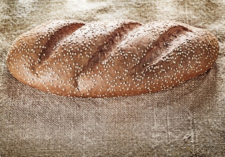 Loaf of bread on burlap background.の写真素材
