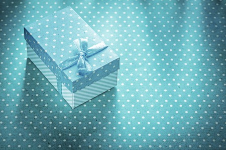 Gift box on blue polka-dot background holidays concept.の写真素材