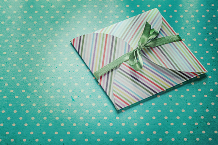 Wrapped present on blue polka-dot tablecloth holidays concept.の写真素材