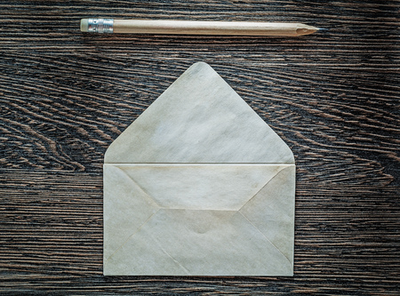 Vintage envelope pencil on black board top view.の写真素材