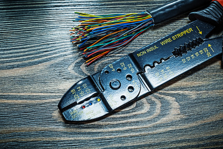 Electric wires insulated stripper on wooden board.の写真素材