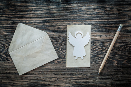 Vintage envelope paper angel pencil on black board.の写真素材