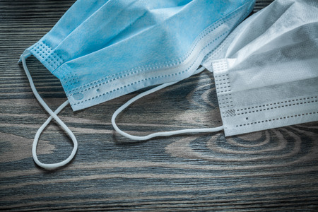 Disposable flu masks on wooden board.の写真素材