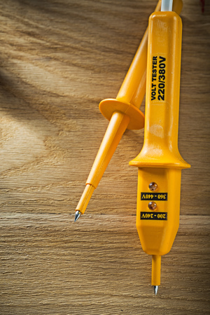 Electric tester on wooden board top view.の写真素材