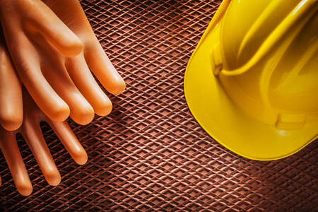 Protective insulating gloves building helmet on dielectric rubber mat.の写真素材