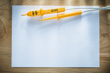 Blank sheet of paper electrical tester on wooden board.の写真素材