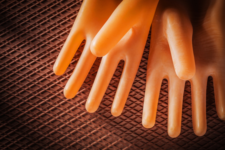Pair of insulating gloves on dielectric rubber mat.の写真素材