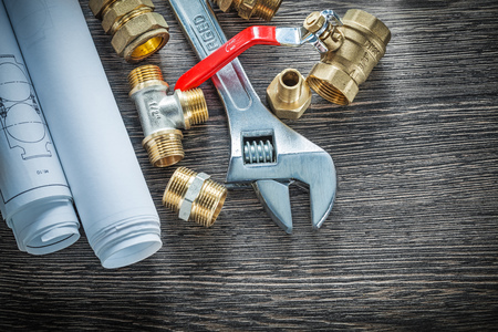 Adjustable wrench plumbing pipe fittings rolled blueprints water valve.の写真素材