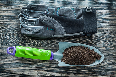 Agriculture shovel soil safety gloves on wooden board.の写真素材