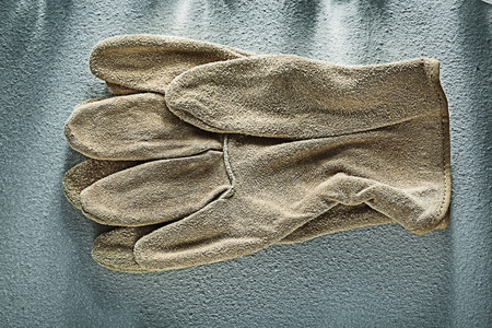 Pair of leather safety gloves on concrete background.の写真素材