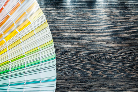 Color sampler fan on wooden board top view.の写真素材
