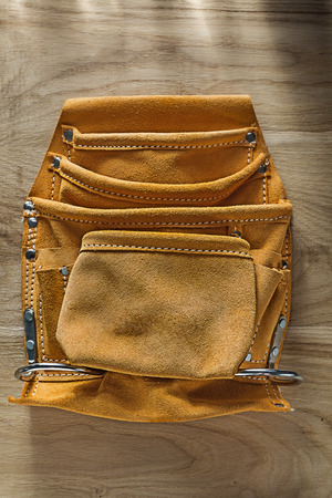 Leather building belt on wooden board.の写真素材