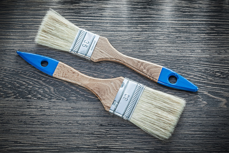 Paintbrushes on wooden board top view.の写真素材