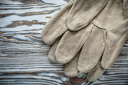Pair of leather safety gloves on wooden board.の写真素材