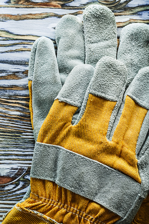 Protective gloves on wooden board top view.の写真素材