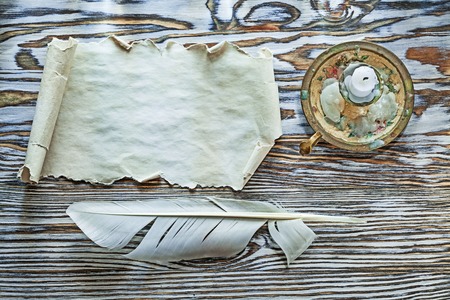 Vintage paper plume candlestick on wooden board.の写真素材