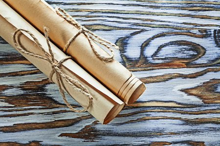 Vintage paper scrolls on wooden board.
