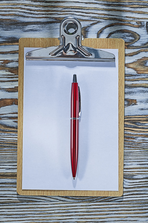 Clipboard paper pen on wooden board.の写真素材
