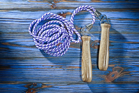Jump rope on vintage wooden board.