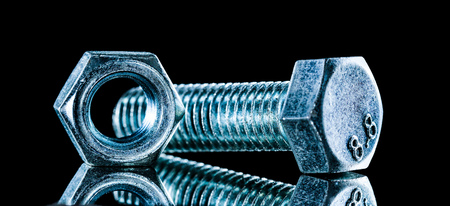 Construction nut bolt detail on black background.