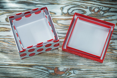 Red gift boxes on wooden background.
