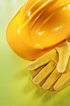 Protective gloves building helmet on yellow background.の写真素材